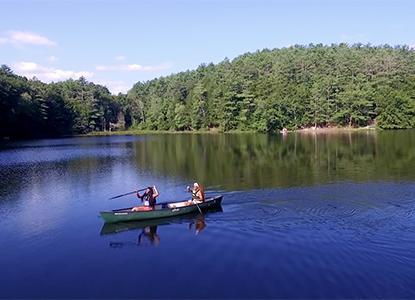 Hartwick College students in canoe on Pine Lake